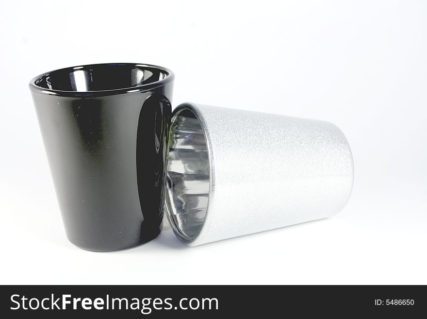 Black and silver shot glasses isolated on white