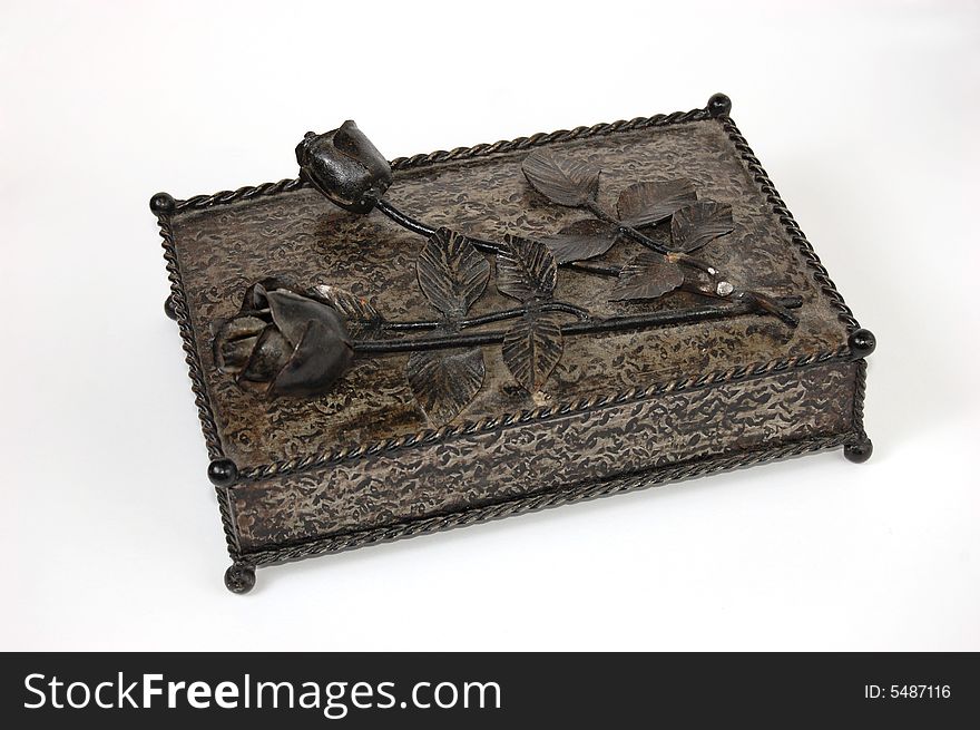 A hand made iron box with roses on the top. A hand made iron box with roses on the top