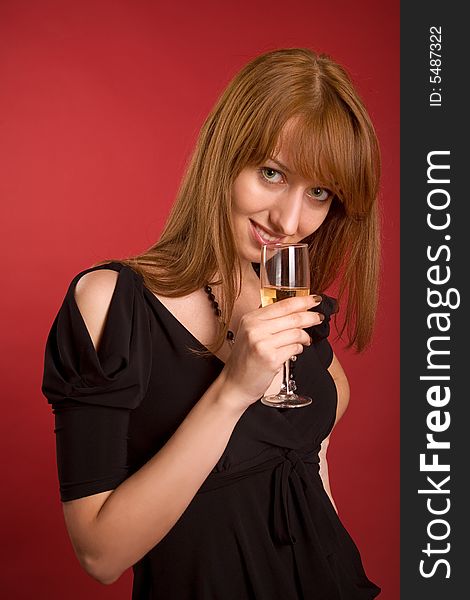 Beautiful girl with champagne glass isolated on red background