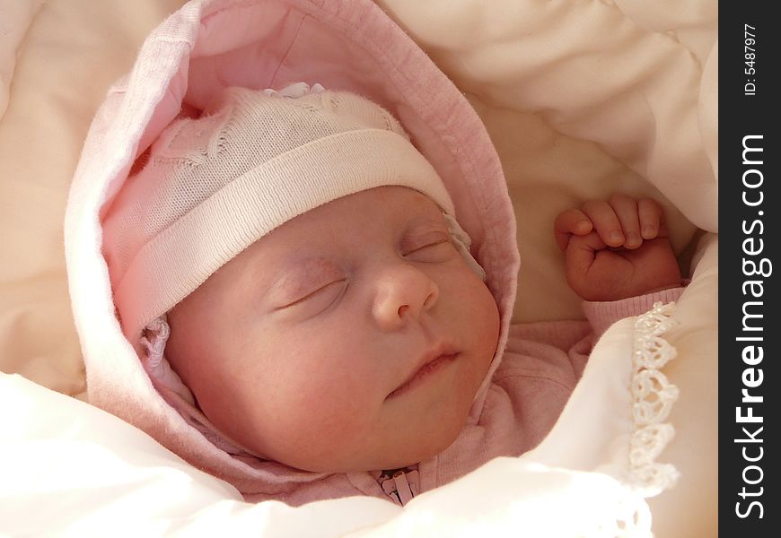 Portrait sleeping newborn baby girl in knitted bonnet, wrapped soft blanket. Portrait sleeping newborn baby girl in knitted bonnet, wrapped soft blanket