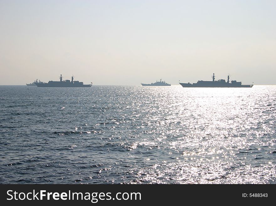 Fully loaded oil tanker and container carrier in the sun, on sea. Fully loaded oil tanker and container carrier in the sun, on sea.