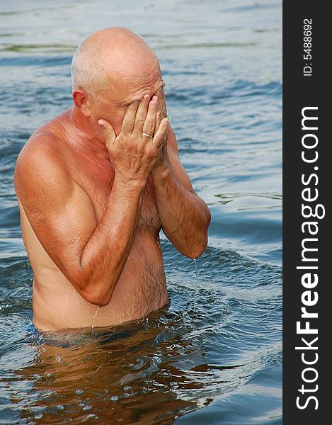 Senior man is relaxing in river water. Senior man is relaxing in river water