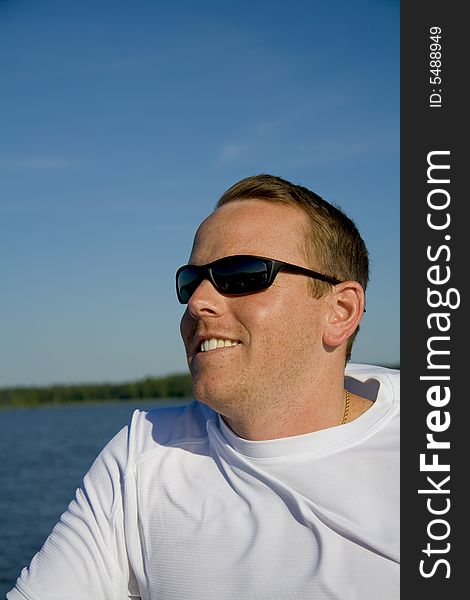 Man wearing sunglasses enjoying a boat ride on a sunny day. Man wearing sunglasses enjoying a boat ride on a sunny day.