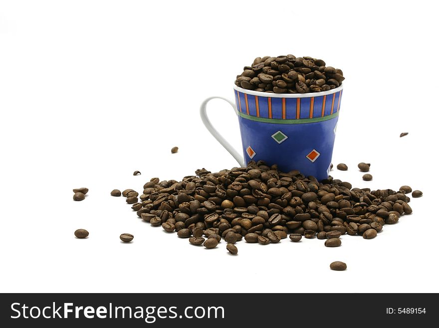 Blue cup and coffee beans isolated on white backround.