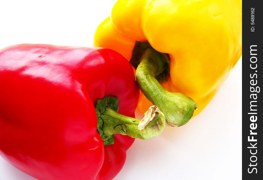 Red and yellow paprika on white background