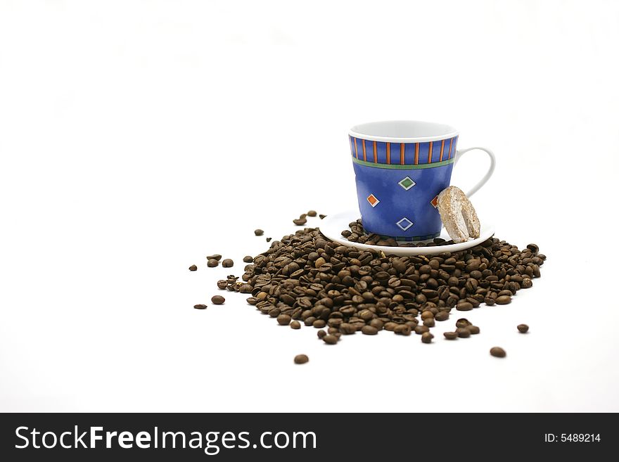 Blue cup, cookie and coffee beans isolated on white backround.