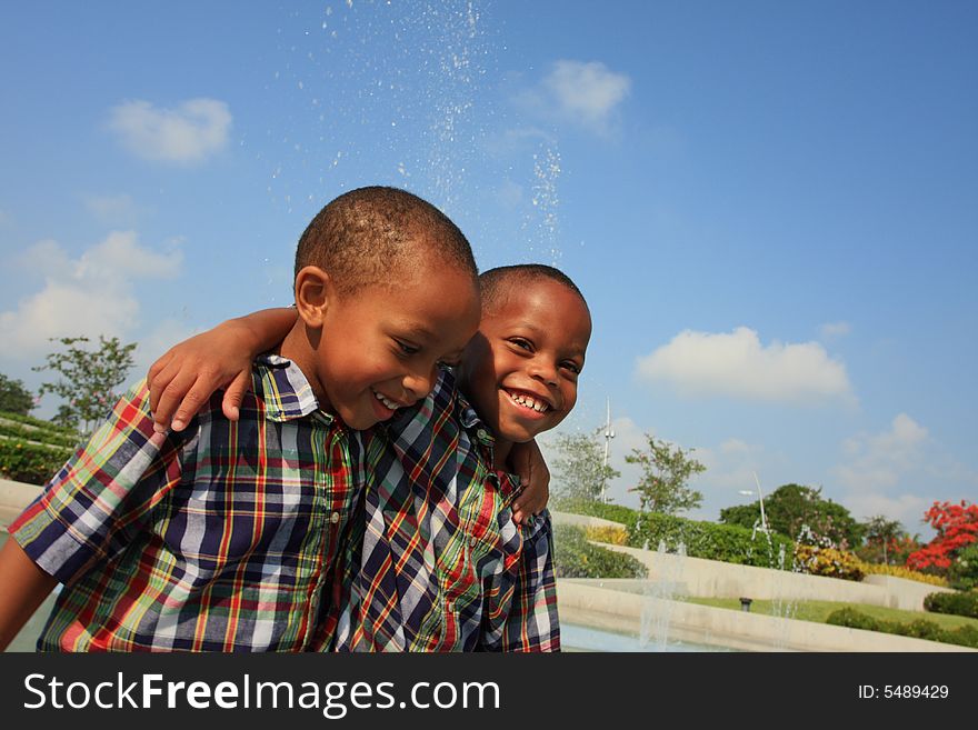 Two brothers walking and laughing together. Two brothers walking and laughing together.