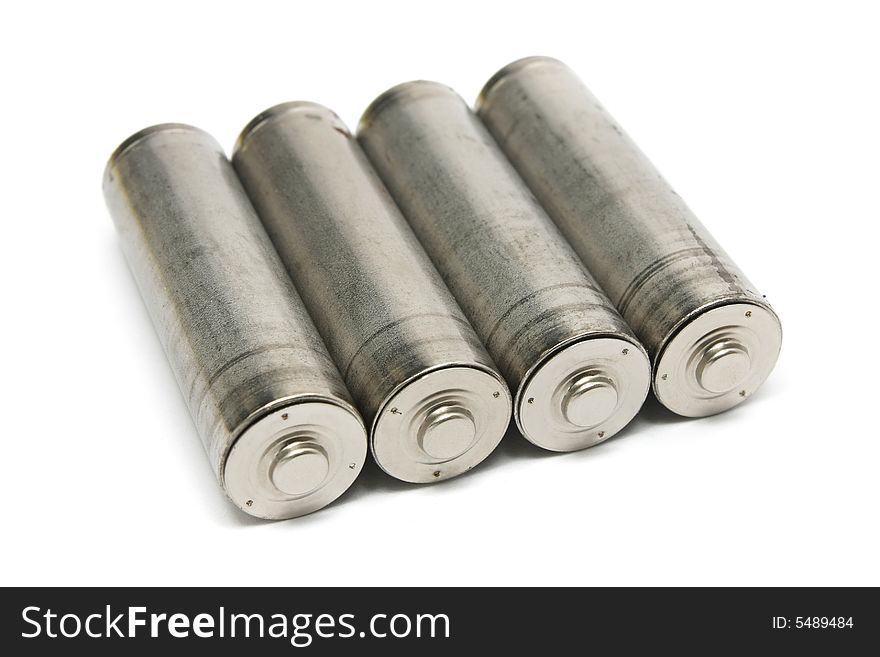 Four AA size batteries isolated on white background. Four AA size batteries isolated on white background.