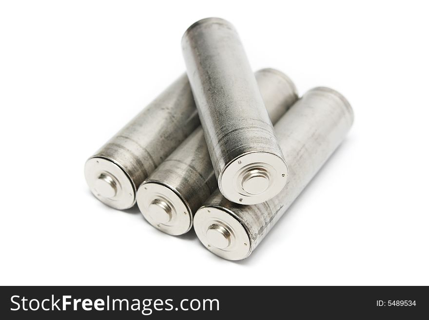 Four AA batteries stacked on white background.