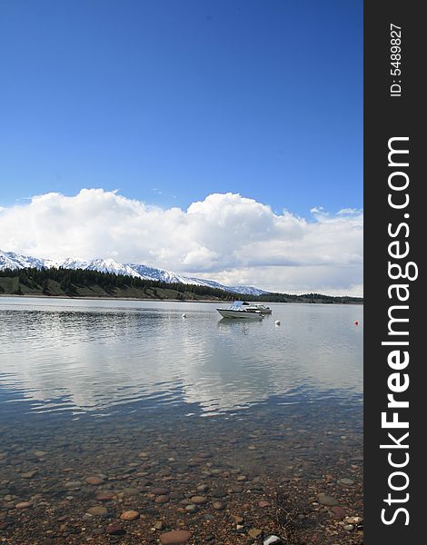 Boat on lake with Mountains in the background