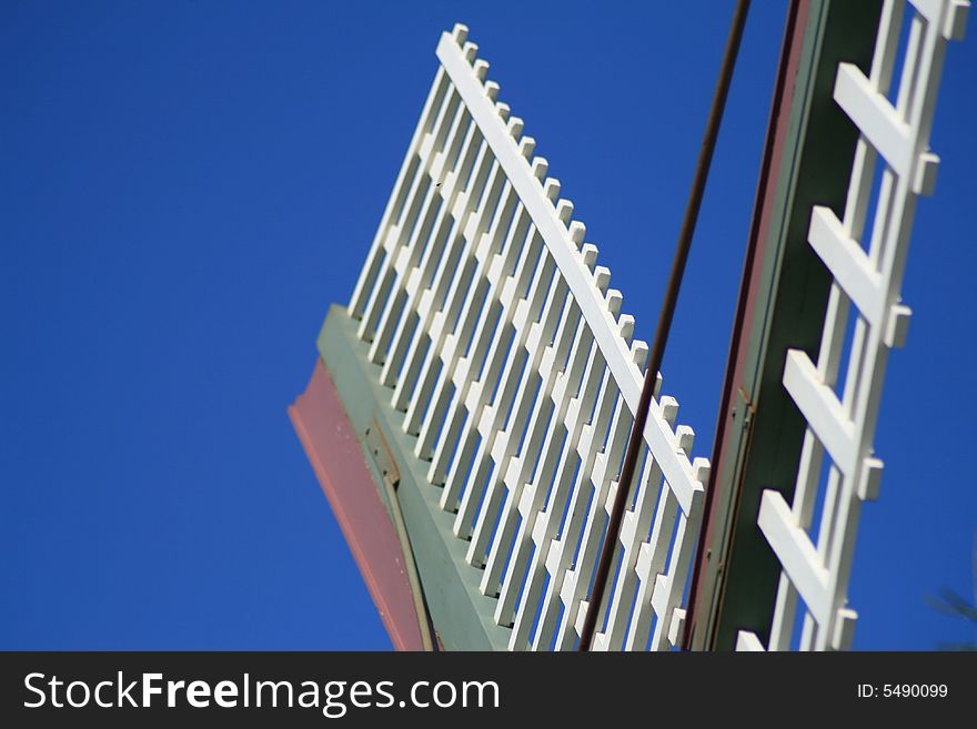 Antique White Windmill Blades set against blue sky