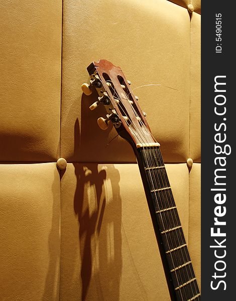 An acoustic guitar with a simple background at night