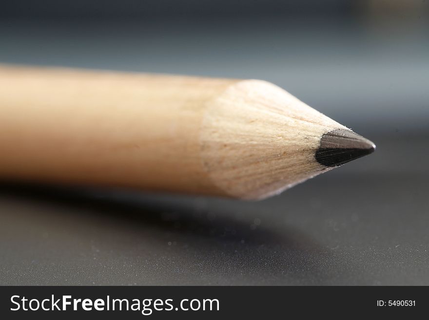 A pencil with a simple black color background. A pencil with a simple black color background