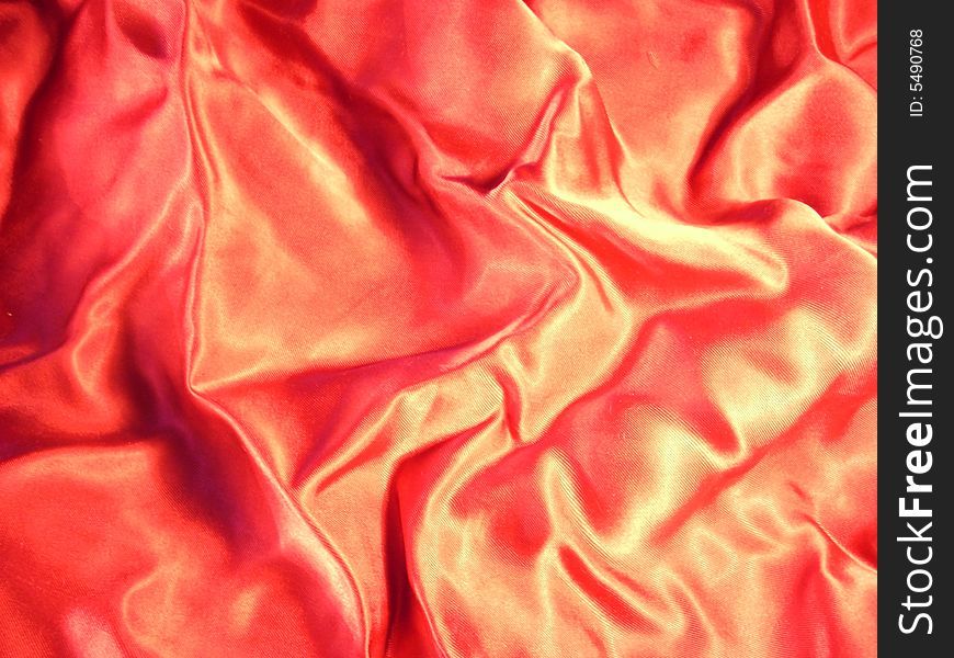 A photograph of red shining material. Fine texture. A photograph of red shining material. Fine texture