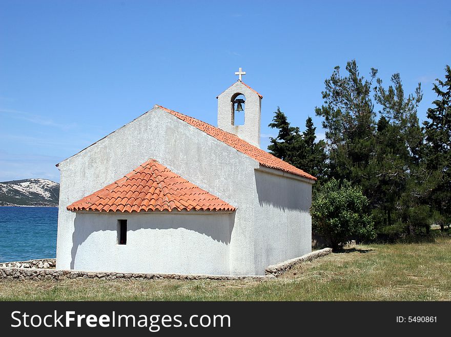 Chapel, small church in a field beside a sea in Mediterranean island in Croatia