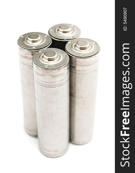 Four AA size batteries standing on white background. Four AA size batteries standing on white background.