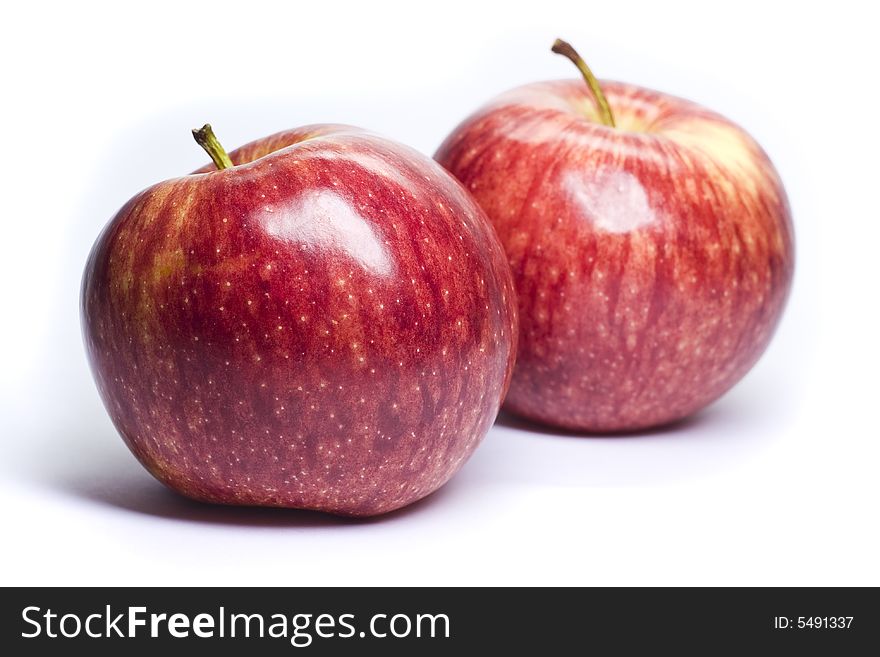 Ripe red apples on a white background