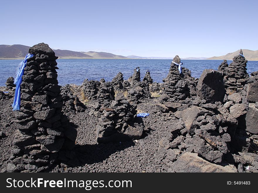 Ovoos, Buddhist stone piles, built by people along the edge of Terkh Lake in central Mongolia. Ovoos, Buddhist stone piles, built by people along the edge of Terkh Lake in central Mongolia