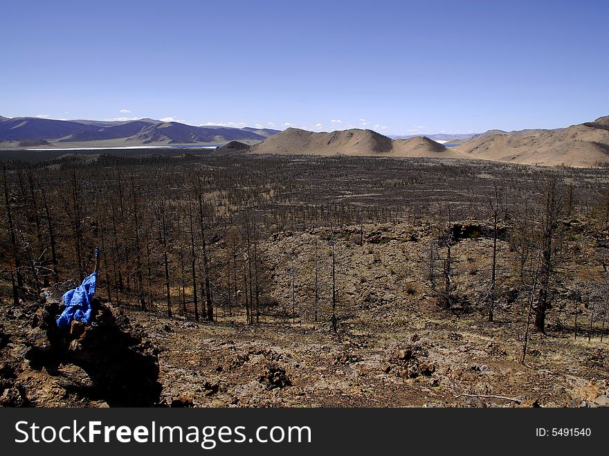 Lava fields and extinct volcanoes scattered across flat volcanic plains around Terkh Lake in central Mongolia. Lava fields and extinct volcanoes scattered across flat volcanic plains around Terkh Lake in central Mongolia