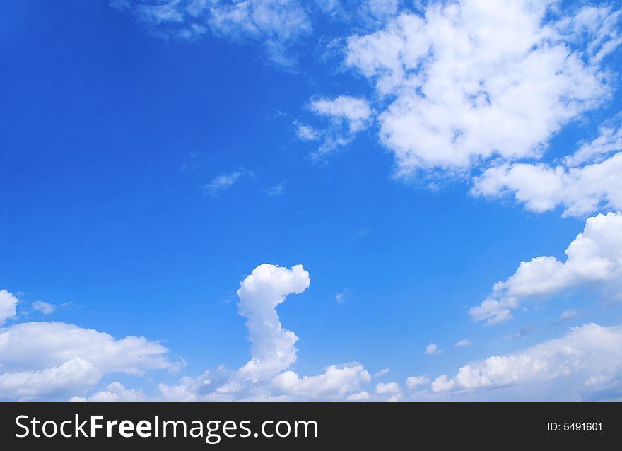 White cloud in the form of the head of dragon against the bright blue background of summer sky. White cloud in the form of the head of dragon against the bright blue background of summer sky.
