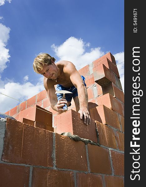 Construction worker building a wall of a house