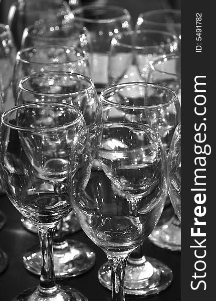 A lot of glasses in readyness for a party in black and white. A lot of glasses in readyness for a party in black and white