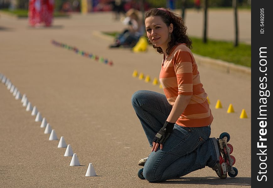 Rollerskating Girl Outdoors on Asphalt Background