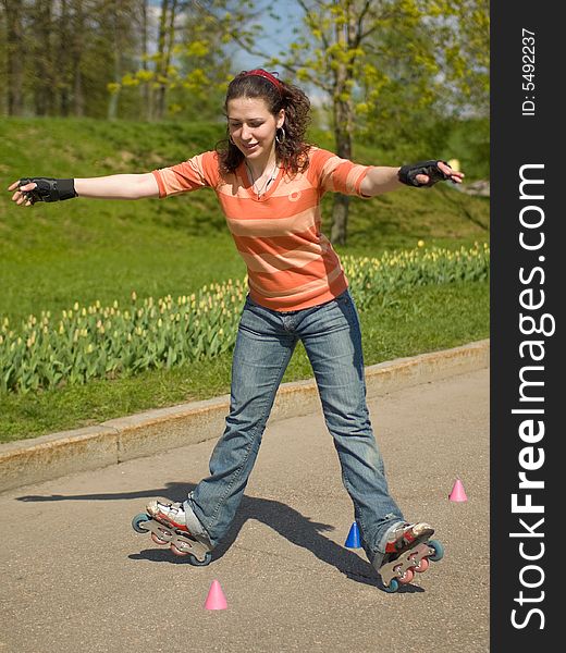 Rollerskating Girl Outdoors on Green Background