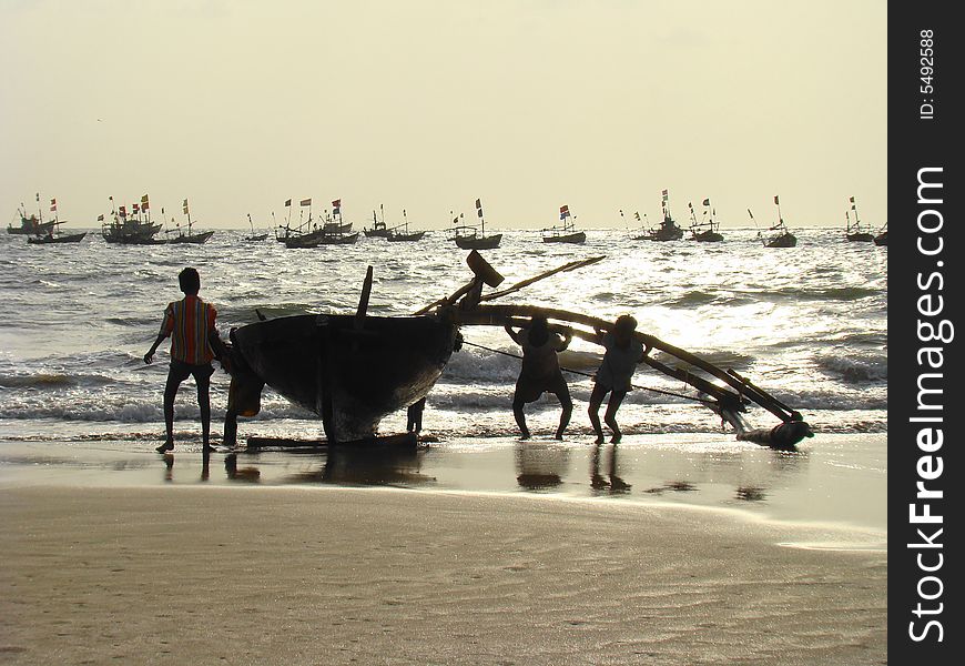 Fishermen bringing the boats back to the shore. Fishermen bringing the boats back to the shore.