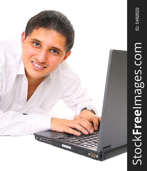 Smiling young man typing on laptop. isolated on white background. Smiling young man typing on laptop. isolated on white background