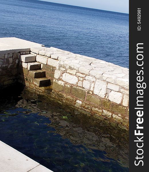 Seaside, white stone quay with stone steps towards the blue sea

*RAW format available. Seaside, white stone quay with stone steps towards the blue sea

*RAW format available