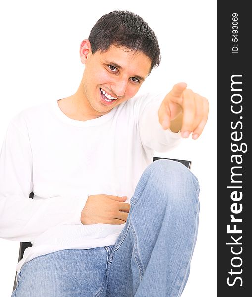 Sitting teenager laughing and pointing his finger. isolated on white background. Sitting teenager laughing and pointing his finger. isolated on white background