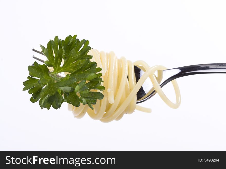 Spaghetti and parsley on a fork