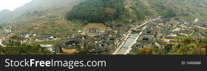 A tulou or earthen building or earch towner, is a traditional communal residence in the Fujian province of Southern China, usually of a circular configuration surrounding a central shrine. These vernacular structures were occupied by clan groups. Fujian Tulou are known for their unique shape, large scale, and ingenious structure. Although most tulou were of earthen construction, the definition tulou, is a broadly descriptive label for a building type and does not indicate construction type. Some were constructed of cut granite or had substantial walls of fired brick. Most large-scale tulou seen today were built of a composite material known as sanhetu rather than just earth. A tulou or earthen building or earch towner, is a traditional communal residence in the Fujian province of Southern China, usually of a circular configuration surrounding a central shrine. These vernacular structures were occupied by clan groups. Fujian Tulou are known for their unique shape, large scale, and ingenious structure. Although most tulou were of earthen construction, the definition tulou, is a broadly descriptive label for a building type and does not indicate construction type. Some were constructed of cut granite or had substantial walls of fired brick. Most large-scale tulou seen today were built of a composite material known as sanhetu rather than just earth.