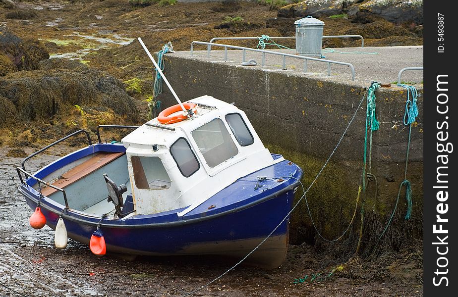Fishing boat at low tide