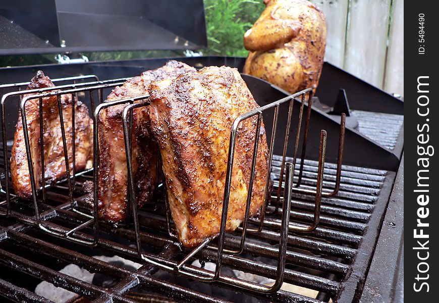 Photo of a rack of pork ribs being cooked on a grill. Photo of a rack of pork ribs being cooked on a grill