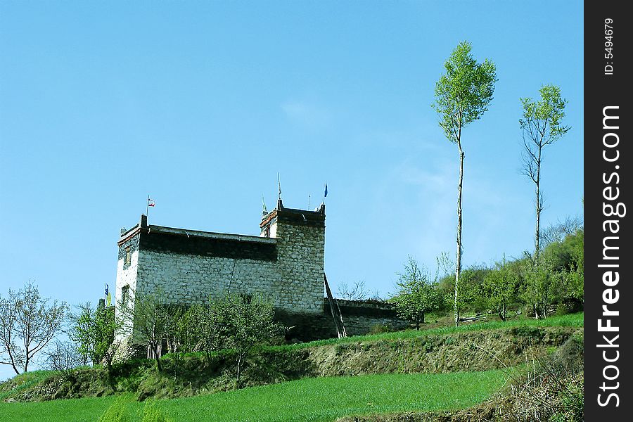Trees and building on mountain with blue air