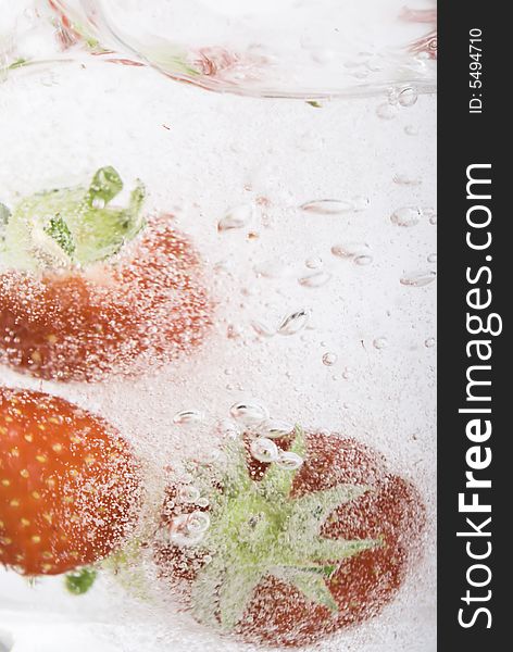 Close up of strawberries splashing in water splash and bubbles. Close up of strawberries splashing in water splash and bubbles