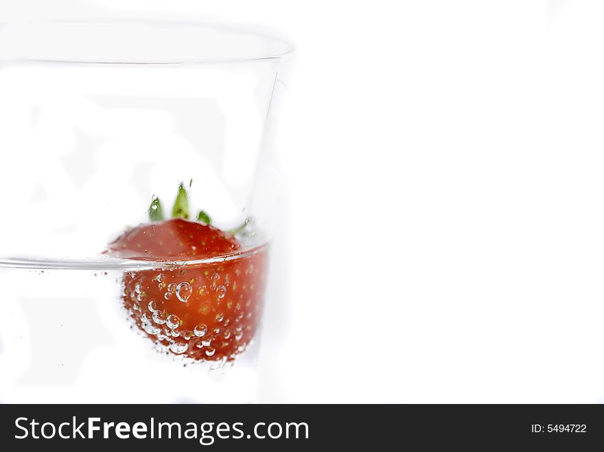 Close up of strawberries splashing in water splash and bubbles. Close up of strawberries splashing in water splash and bubbles