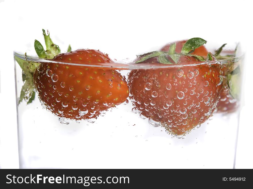 Close up of strawberries splashing in water splash and bubbles. Close up of strawberries splashing in water splash and bubbles