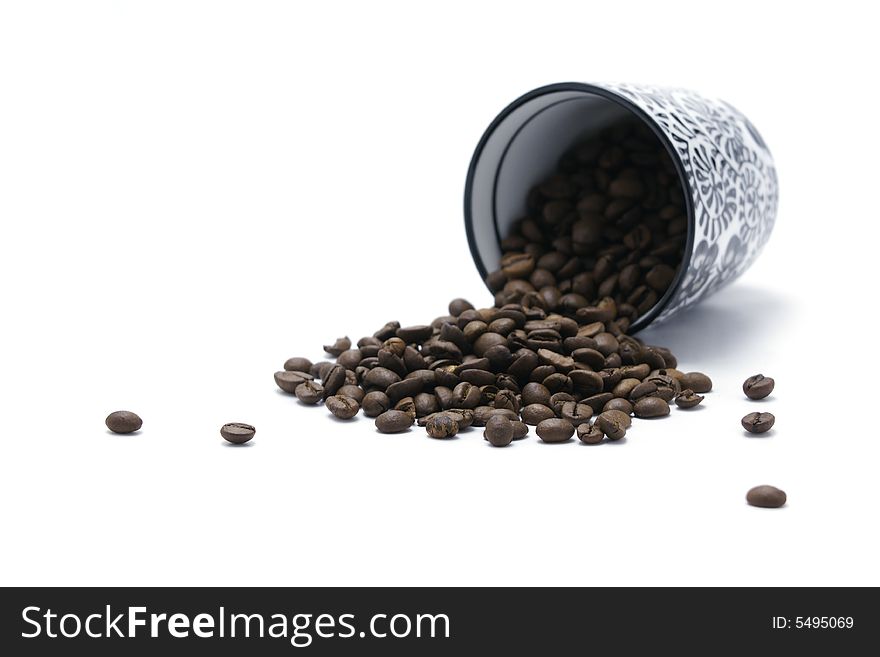 Cup And Coffee Beans Focus On Beans isolated on white backround. Cup And Coffee Beans Focus On Beans isolated on white backround.