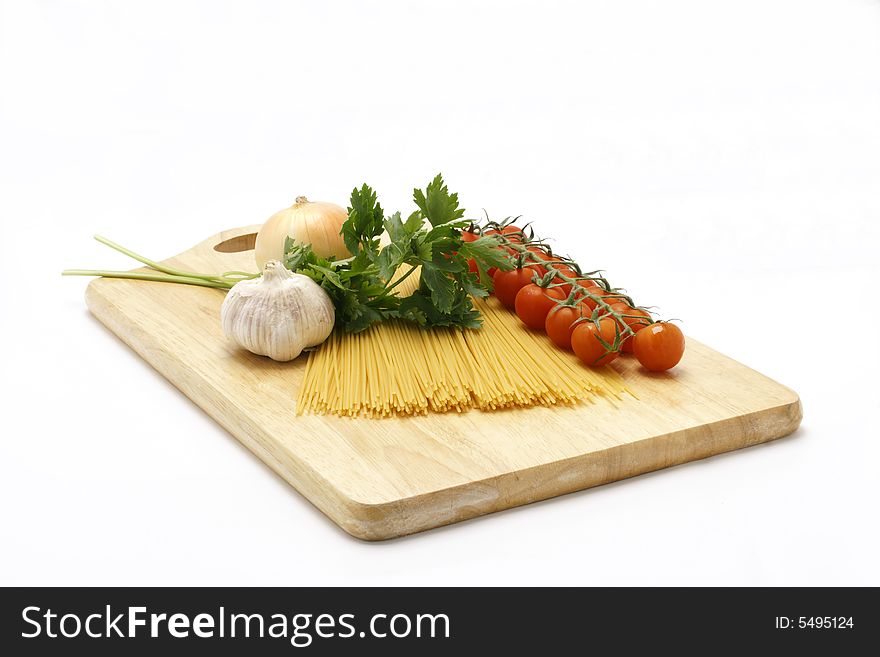 Pasta Ingridients - onion garlic tomato and pasta isolated on white backround.