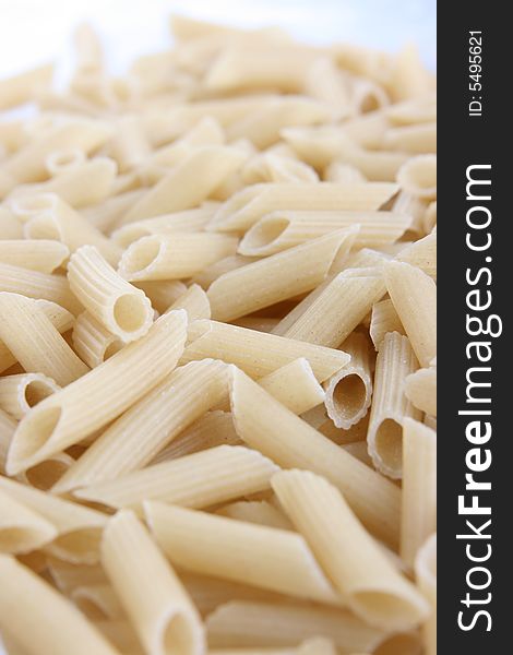 Many uncooked noodles on the white background