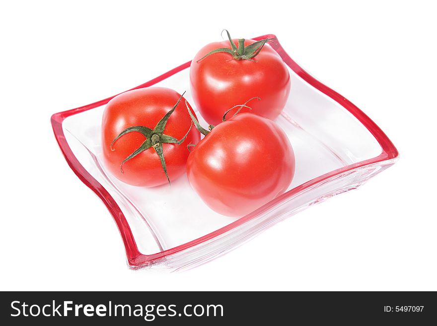 Red tomatoes on a glass plate,isolated. Red tomatoes on a glass plate,isolated.