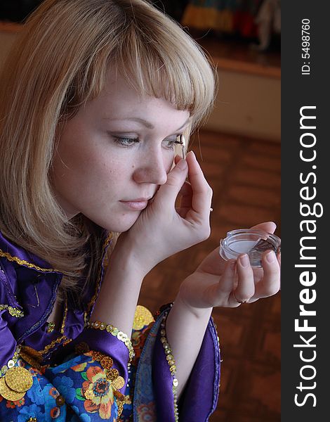 The girl applies cosmetics before performance at a concert. The girl applies cosmetics before performance at a concert