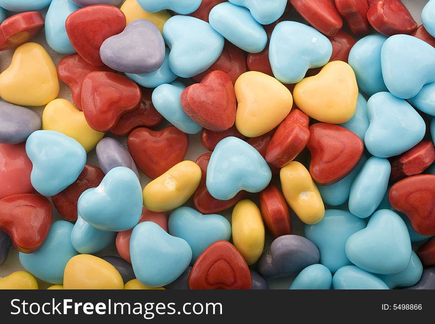 Heart shaped colorful candies background