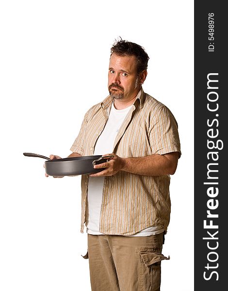 Man holding frying pan with sad look