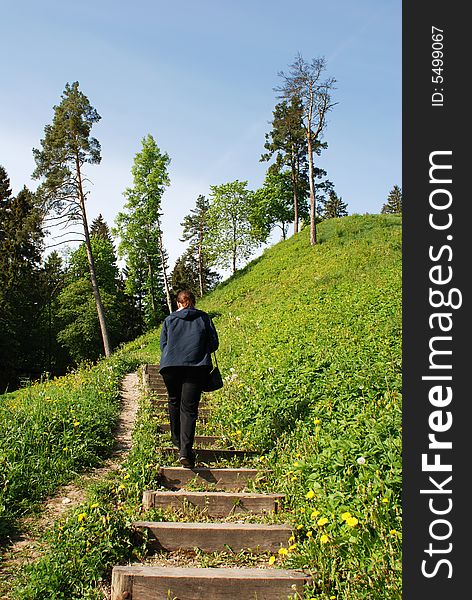 The girl is climbing to Birstonas resort town mound (Lithuania). The girl is climbing to Birstonas resort town mound (Lithuania).