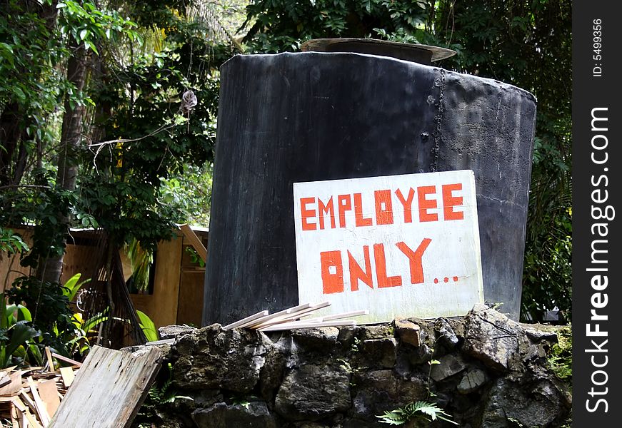 A homemade employee only sign at a  old distillery.