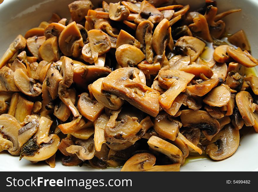 A Plate of oily cold stewed mushrooms after the meal.